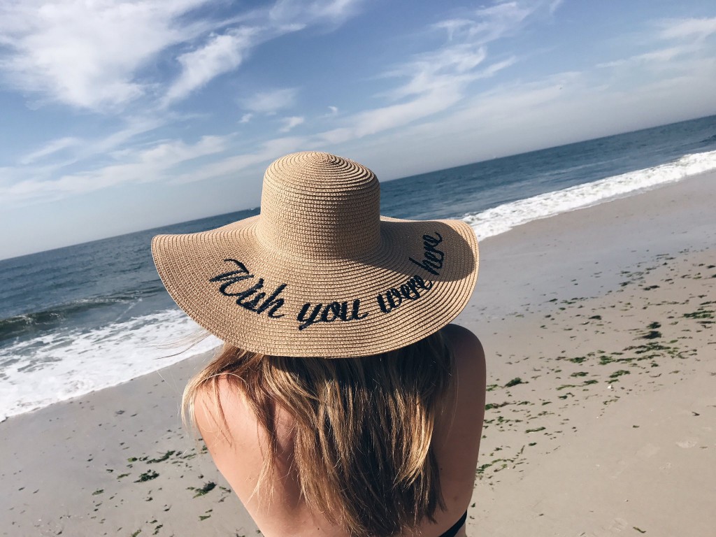 Julie took to the beach in Delaware to have some fun in the sun. We love her embroidered hat and one-piece!